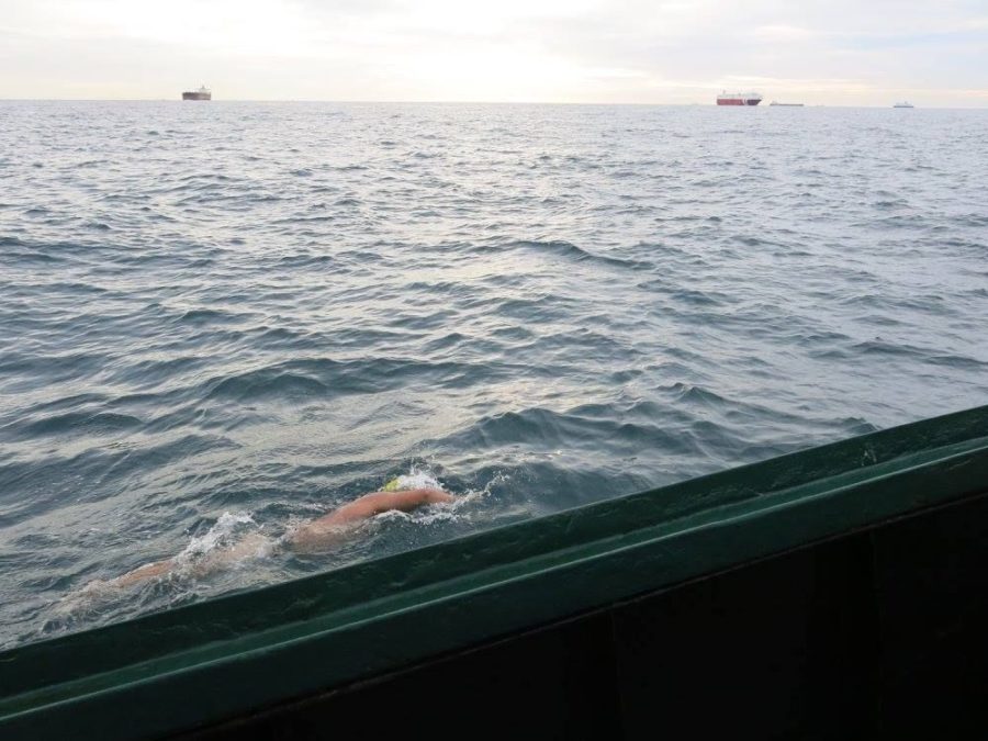 Adam Grimm, senior in horticulture, and his crew catch a view of two shipping boats during his swim across the English Channel.