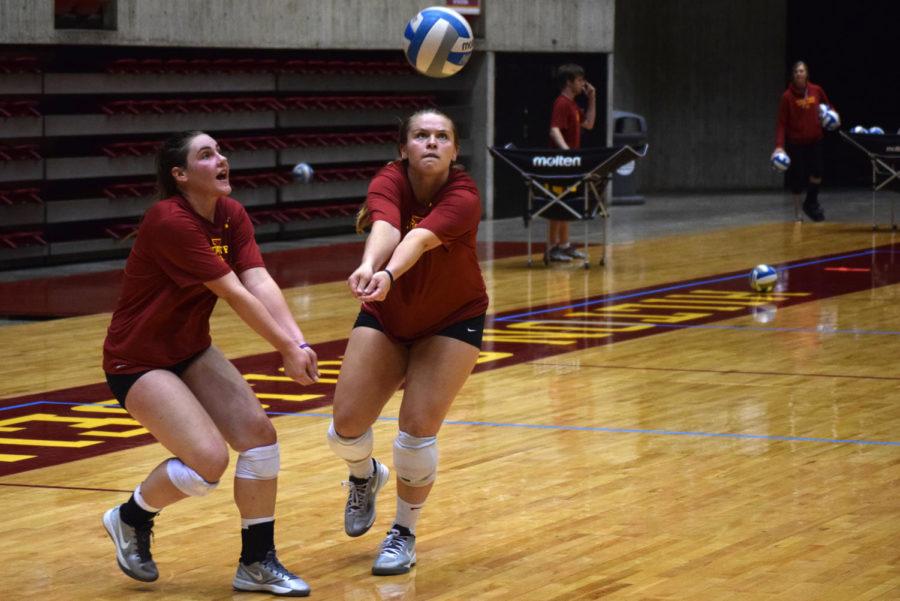Senior Caitlin Nolan (right) and sophomore Branen Berta (left) both move to return a ball at the teams open practice on Tuesday, August 18 at Hilton Coliseum.