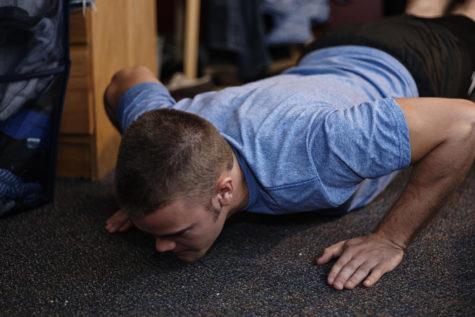 To perform a push-up, start in a plank and then slowly lower your body to the floor, keeping elbows close to the ribs and the entire body parallel to the ground. 