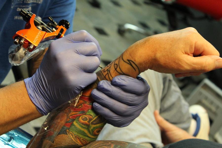Hot Rod adds to his clients tattoo sleeve at The Asylum.