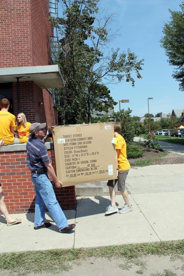 Residence hall crew members help new students move into dorms on campus. 