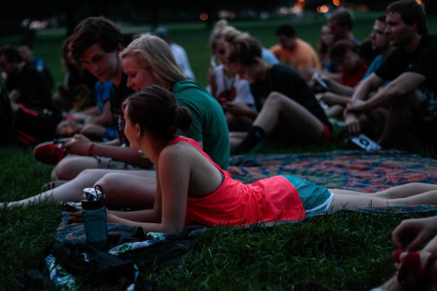 Students sit in front of the campanile Monday night to listen to MOVE. MOVE is a new student group on campus aiming to provide motivational talks and a supportive community.