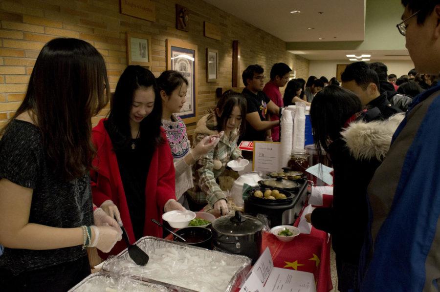 The Chinese Students and Scholarship Association creates samples for the International Foods Night. The event was held on Nov. 13, 2014 at St. Thomas Aquinas Church.