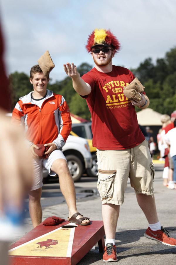 Dillon Bechtol, junior in communication studies, tosses a bag while tailgating at the football game against North Dakota State on Aug. 30.
