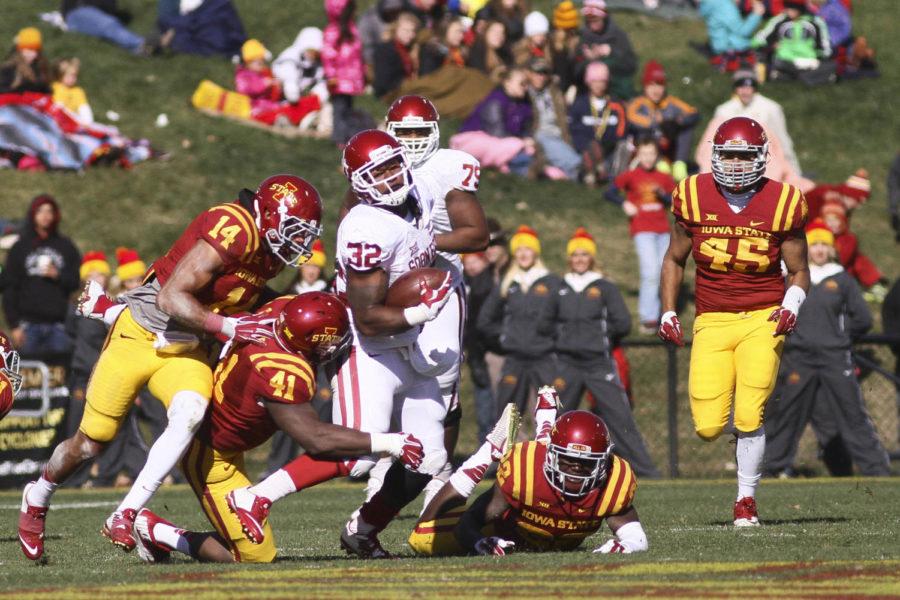 Members of the defensive line chase after the Oklahoma ball carrier on Nov .1 at Jack Trice Stadium. The Cyclones suffered their 16th straight loss to the Sooners with a final score of 59-14. The Cyclones allowed 751 yards of offense to Oklahoma.