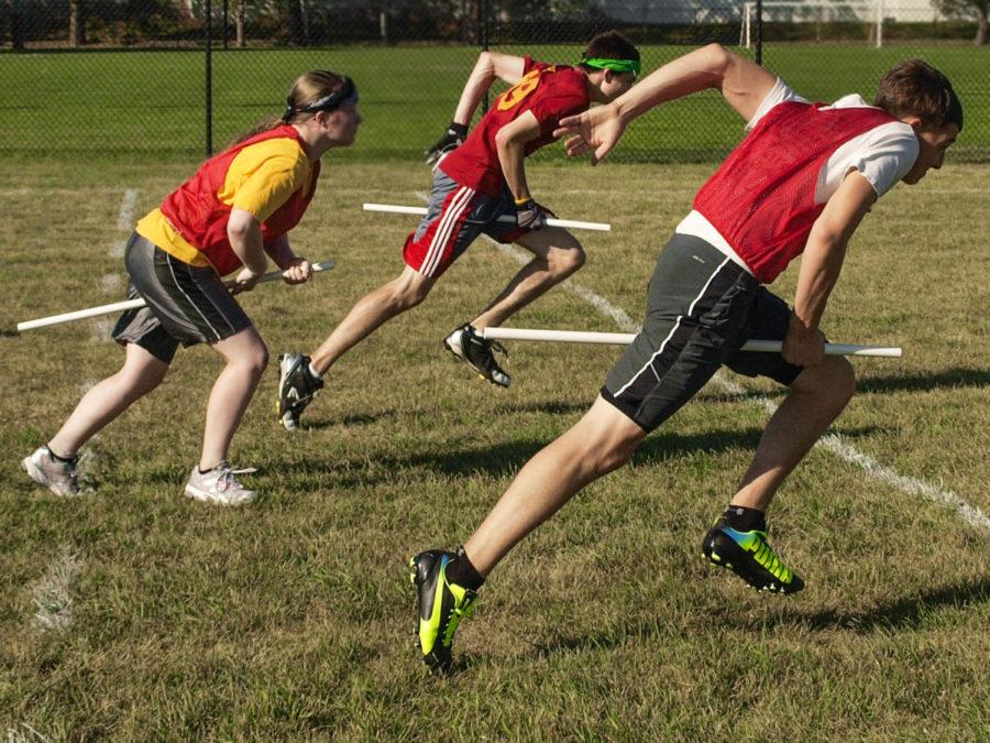Renee Alexander, Adam Cich and Garret Meier take off on broomstick at the start of a Quidditch match. Iowa States team is a school sponsored club that competes at a collegiate level around the Midwest.