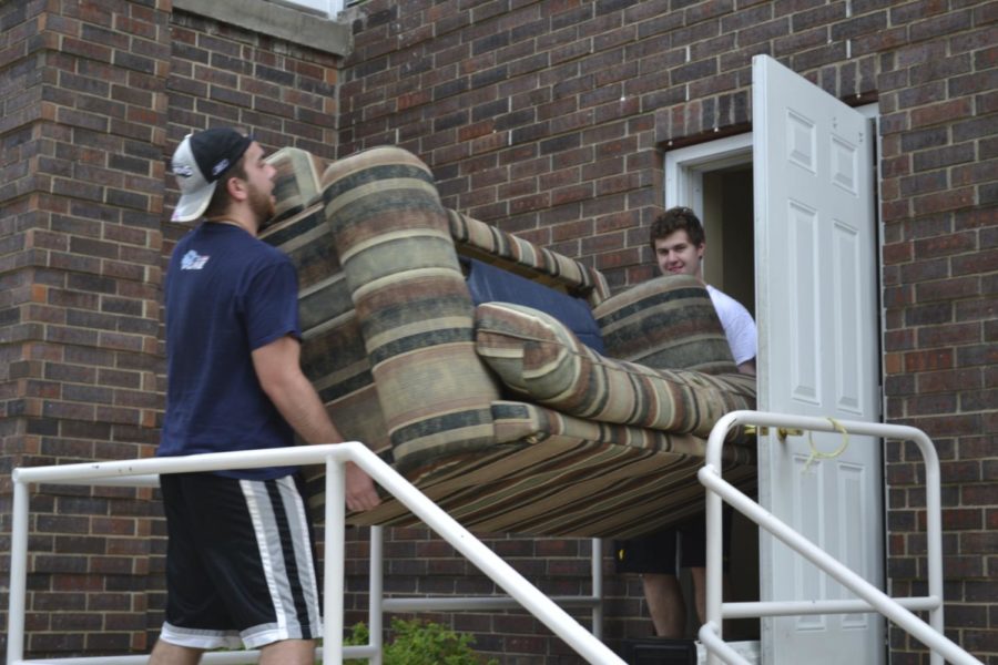 University of Iowa seniors Alec Lombardo (left), 21, and Steven Moioffer, 20, move furniture out of an apartment on 408 S. Van Buren St. in Iowa City on July 28, 2015. Leases for apartments students typically rent usually expire on July 31 each year. Lombardo, who rented from Apartments Near Campus, said he would not know until mid-August whether or not he receives any of his deposit but has friends who had difficulties with Apartments Downtown, whose owner is the same as Apartments Near Campus owner.