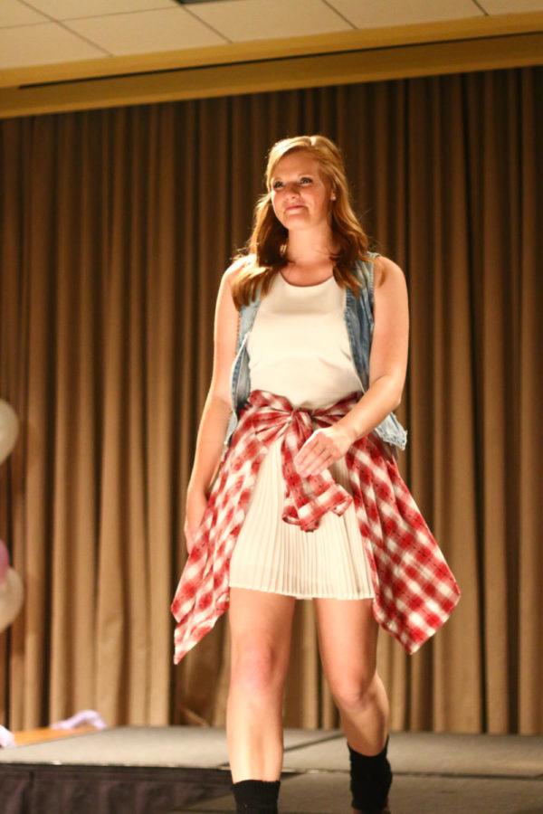 A model walks down the runway wearing clothing from local boutique Portobello Road. The fashion show, which was held Saturday night in the Memorial Union, is an annual philanthropic event put on by Sigma Kappa to raise money for Alzheimer's Disease research. 