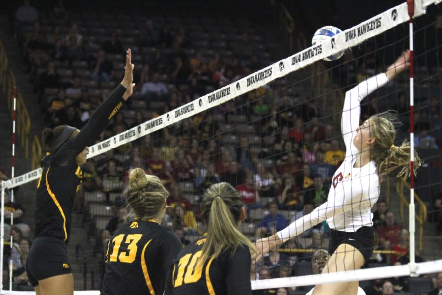 Sophomore middle blocker Alexis Conaway spikes the ball over an Iowa defender. Conaway had 12 kills and a .632 hitting percentage in the 25-17, 17-25, 18-25, 26-28 loss on Friday.