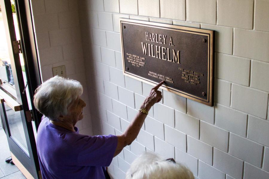 Myrna Wilhelm Elliott marvels at a plaque inside Wilhelm Hall displaying her fathers name and his achievements, during a visit on Sep. 9.  