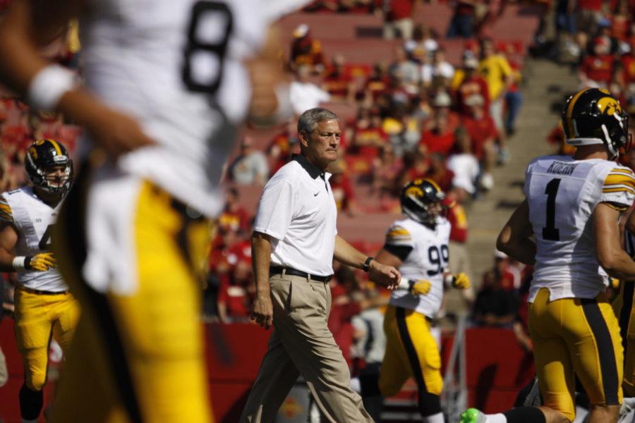 Josh Newell/Iowa State Daily University of Iowa coach Kirk Ferentz walks onto the field Saturday before the first quarter at Jack Trice Stadium. The Cyclones lost to the Hawkeyes 31-17 with the Hawkeyes scoring two touchdowns in the fourth quarter to cinch the trophy.