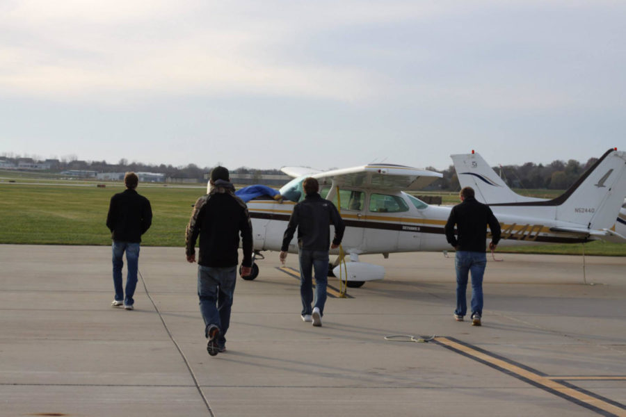 The Iowa State Flying Cyclones club members board an airplane.