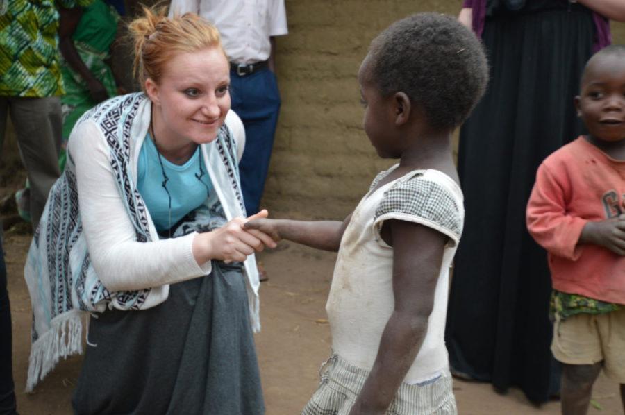 Olivia Reicks, senior in supply chain management, works with a Malawi child during her Land OLakes fellowship. 