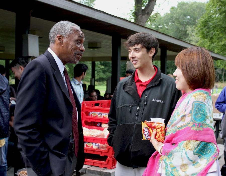 Tom Hill, senior vice president for student affairs, talks with Cory Kleinheksel, center and Eun Jung, right. The annual Graduate and Professional Student Senate picnic took place at Brookside Park on Sept. 5 was a success with many people attending.