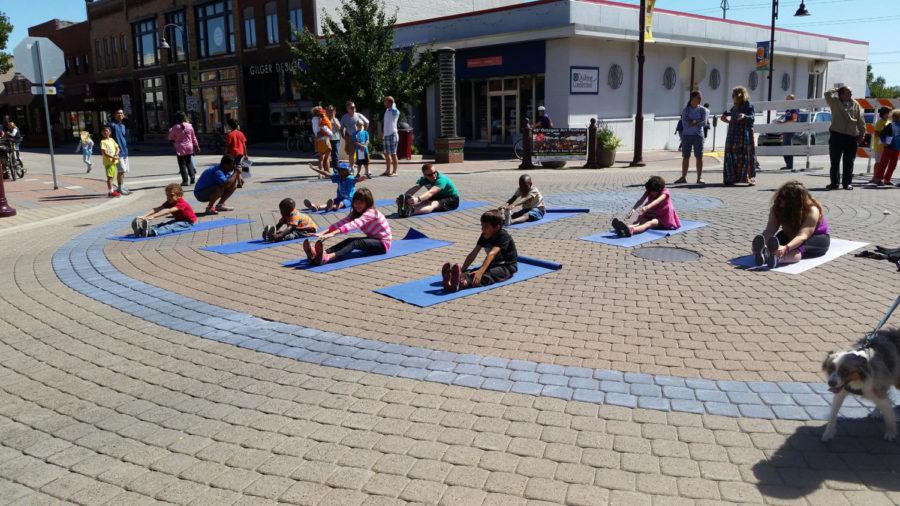 Participants+of+Healthy+Streets+in+downtown+Ames+enjoy+a+free+yoga+session+on+Sept.+20.