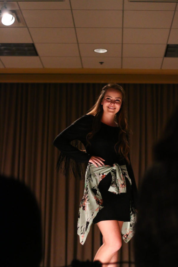 A model poses on the runway wearing clothing from local boutique Portobello Road. The fashion show, which was held Saturday night in the Memorial Union, is an annual philanthropic event put on by Sigma Kappa to raise money for Alzheimer's Disease research. 