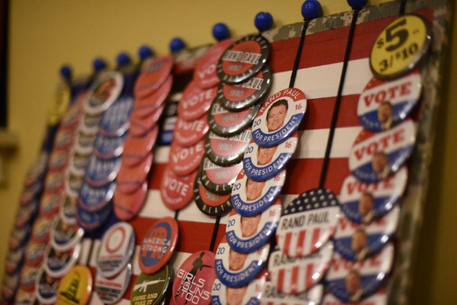 Josh Newell/Iowa State Daily Rand Paul buttons sit on racks during a rally Friday September 11, 2015 in the Sun Room of the Memorial Union in Ames, Iowa. Senator Paul spoke for about an hour to a standing room only audience, who gave him a standing ovation once he finished speaking.