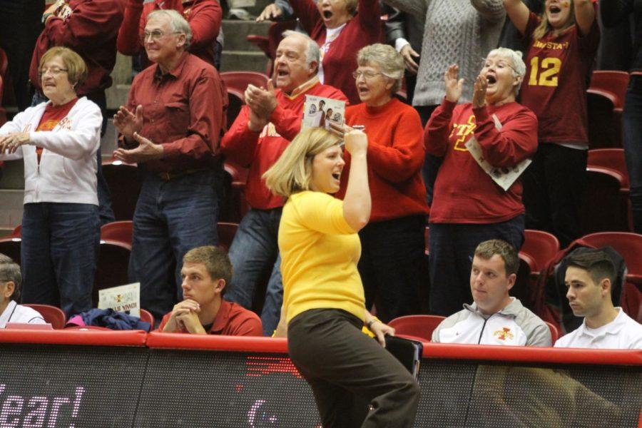 Head coach Christy Johnson-Lynch yells and shows excitement toward the bench after winning 25-22, 20-25, 25-21, 28-26 against Oklahoma on Oct. 12, 2014.