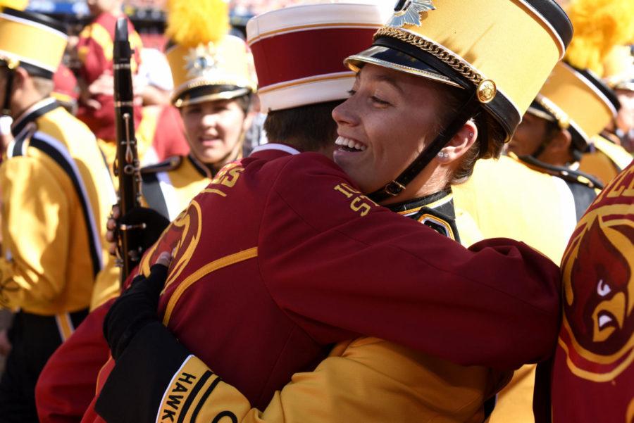 A member of the Cyclone marching band hugs a friend in the Hawkeye band at Jack Trice Stadium. The Cyclones lost to the Hawkeyes 31-17 with the Hawkeyes scoring two touchdowns in the fourth quarter to cinch the trophy. Josh Newell/Iowa State Daily 