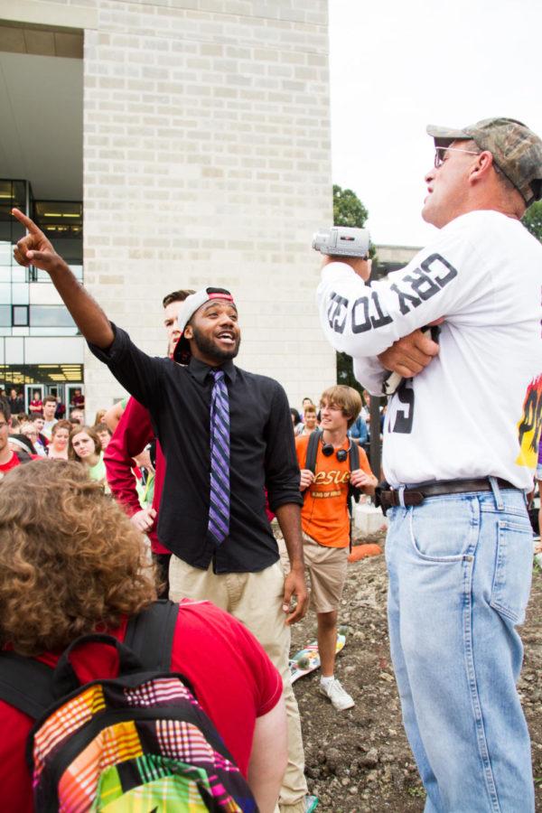 Matt Bourgault (R) argues with sophomore Deonta Motley (L) about what the bible says, outside Parks Library on Sep. 22.