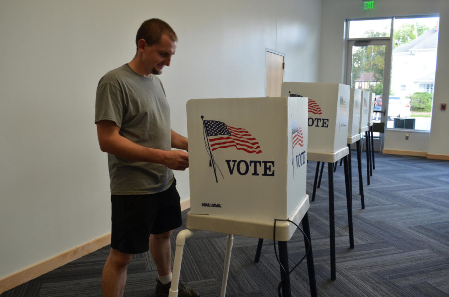 Tom Keinert, Ames resident, turns in his ballet for the Ames School Board elections at the Ames Public Library. The library was a voting place in Tuesdays election. 