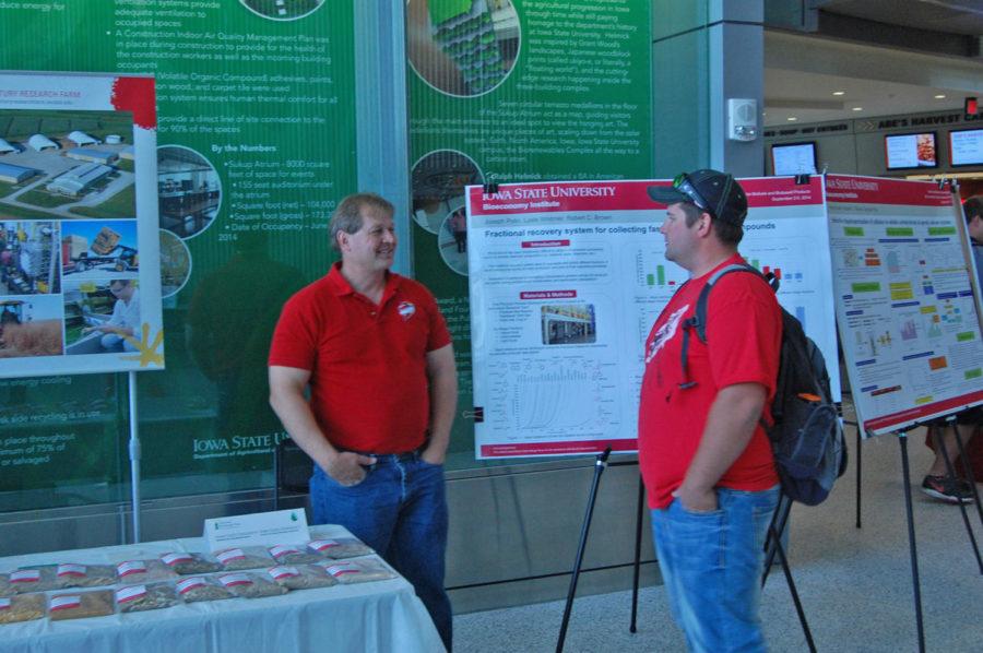 BioCentury manager Andy Suby talks to a student about the BioCentury Research Farm at the National Biorenewables Day event in the Sukup Atrium on October 21.