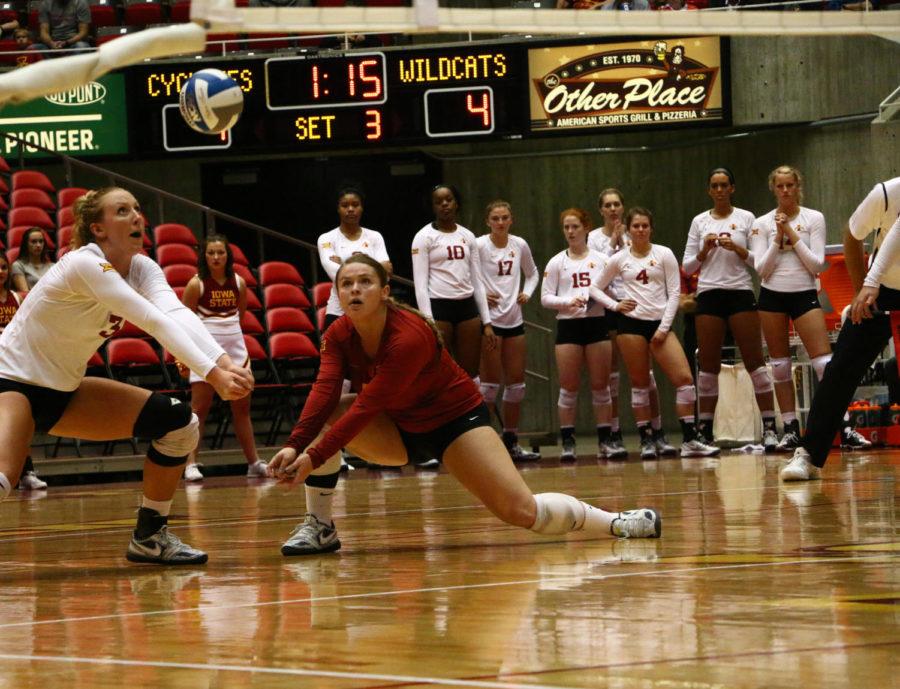 Caitlin Nolan, senior, and Morgan Kuhrt, redshirt junior, reach to bump the ball during the game against Kansas State. The Cyclones beat the Wildcats 3-0. 