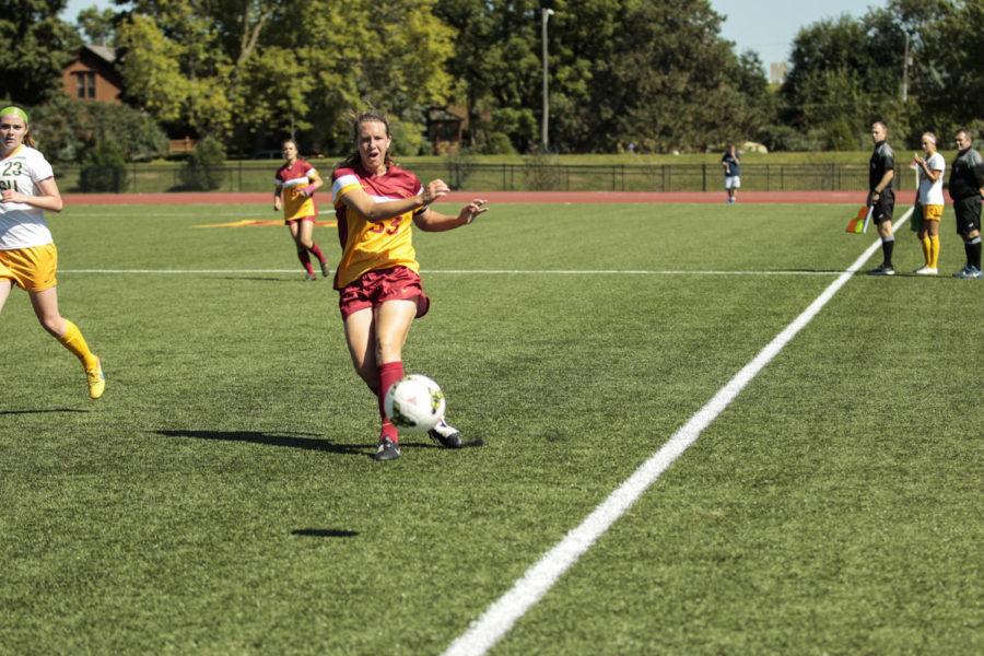 Senior Haley Albert passes the ball down the field to redshirt junior Mia McAleer. The Cyclones lost 2-3 in overtime.