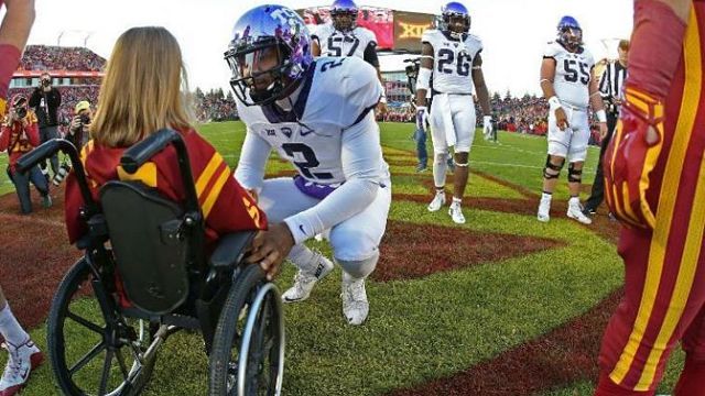 TCU quarterback Trevone Boykin crouches to meet Abby Faber before the football game on Oct. 17. 