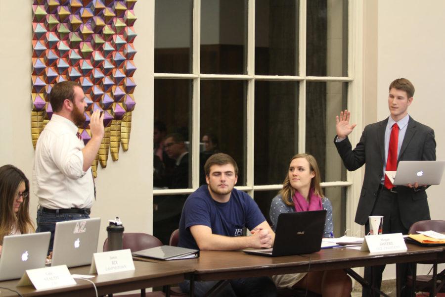 Curtis Richards, junior in electrical engineering, represents Frederiksen Court and transfer students as he is sworn into his new position as a senator. 
