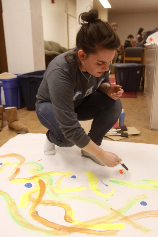 Katie Wilson, freshman in chemical engineering, makes banners for Fall Fest on Wednesday, Nov. 13, at Friley.