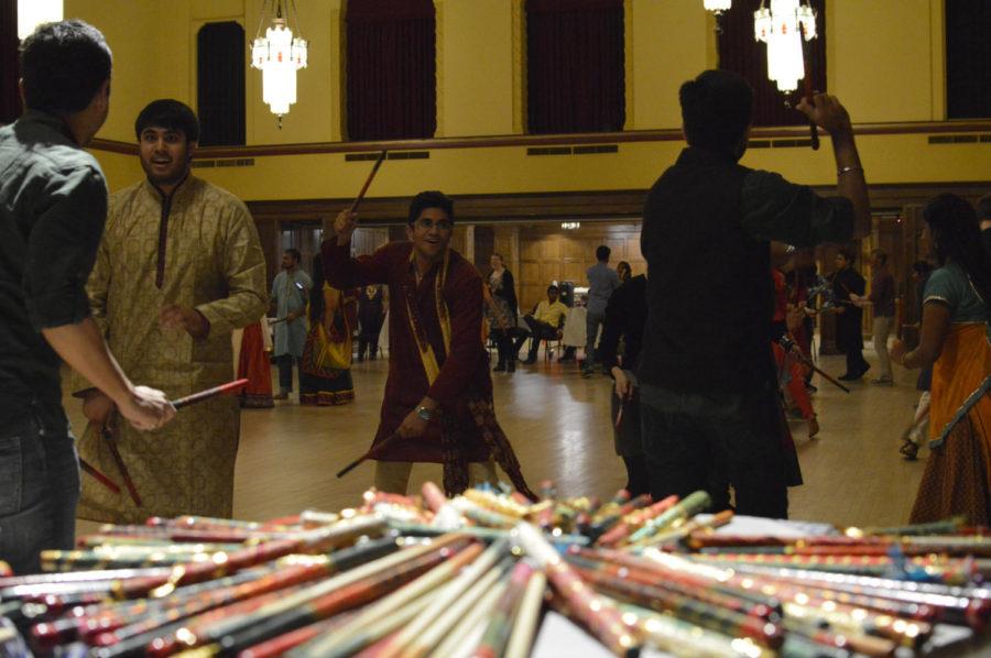 Students take from a table of Dandiya sticks to perform Dandiya Raas, a traditional Indian folk dance, during the Indian Students Association Dandiya Night 2015. The dance is performed along the Garba dance during the festival of Navratri.