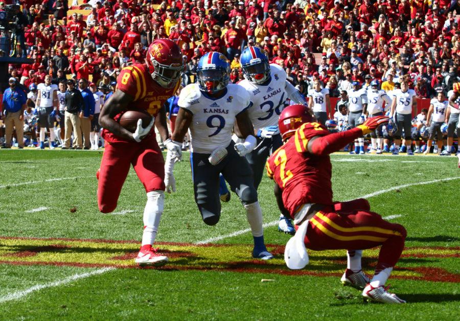 Iowa State wide reciever DVario Montgomery runs with the ball before ultimately being brought down by Kansas safety Fish Smithson. The Cyclones would go on to beat the Jayhawks 38-13. 