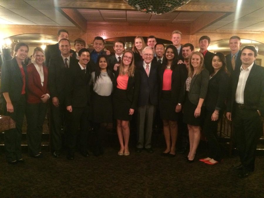 Warren Buffett, CEO of Berkshire Hathaway, poses for a photo with students from Iowa State.