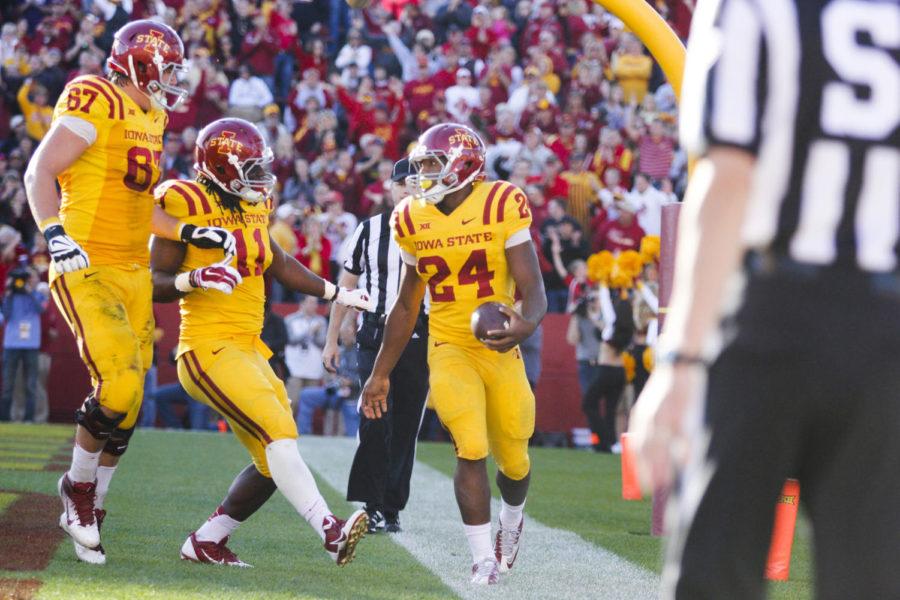 Redshirt freshman lineman Jake Campos and senior tight end EJ Bibbs celebrate freshman running back Martinez Syrias touchdown during the Homecoming game against Toledo on Oct. 11 at Jack Trice Stadium. The Cyclones defeated the Rockets 37-30.
