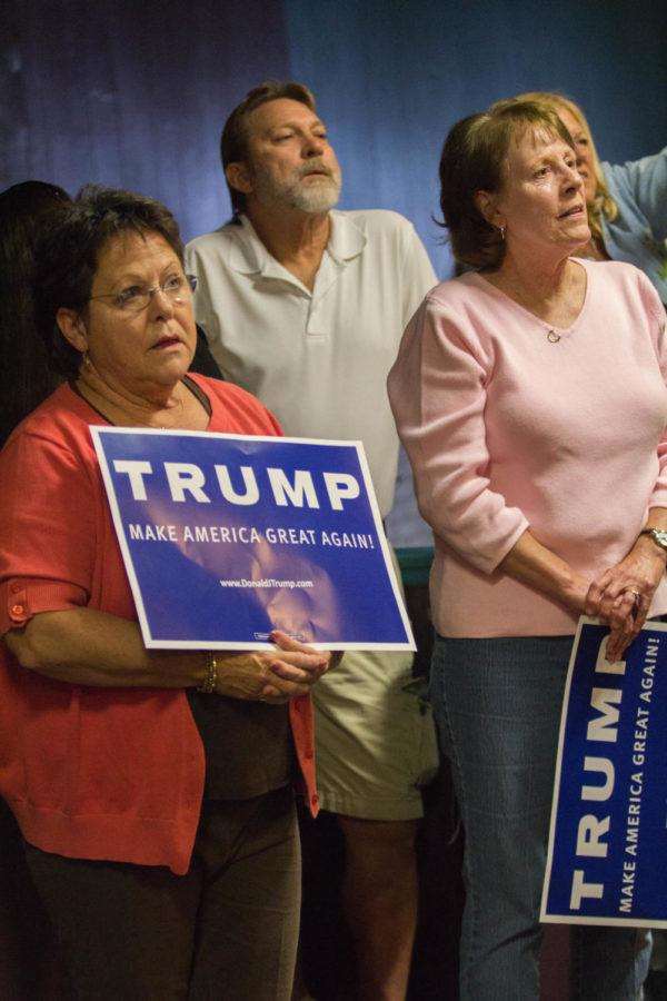 Supporters of Republican presidential candidate Donald Trump look on at a rally in Waterloo, Iowa on Wednesday, Oct. 7, 2015.