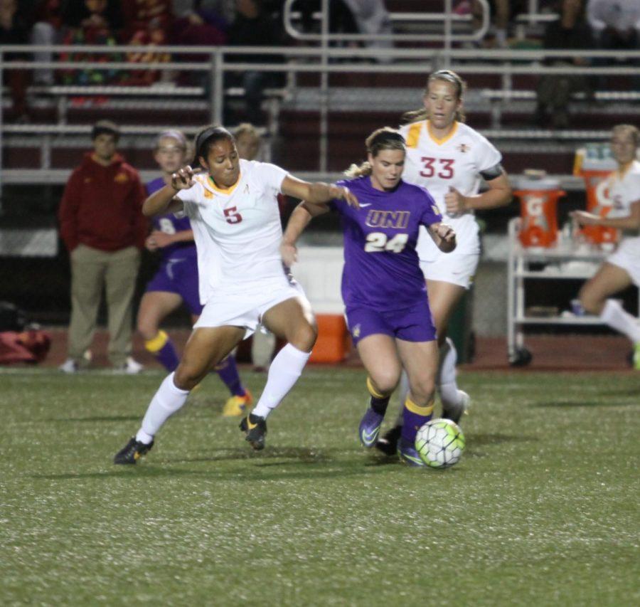 Junior defender Brianna Johnson grabs onto a Northern Iowa player and tries to kick the ball out in the 1-0 win against Northern Iowa. 