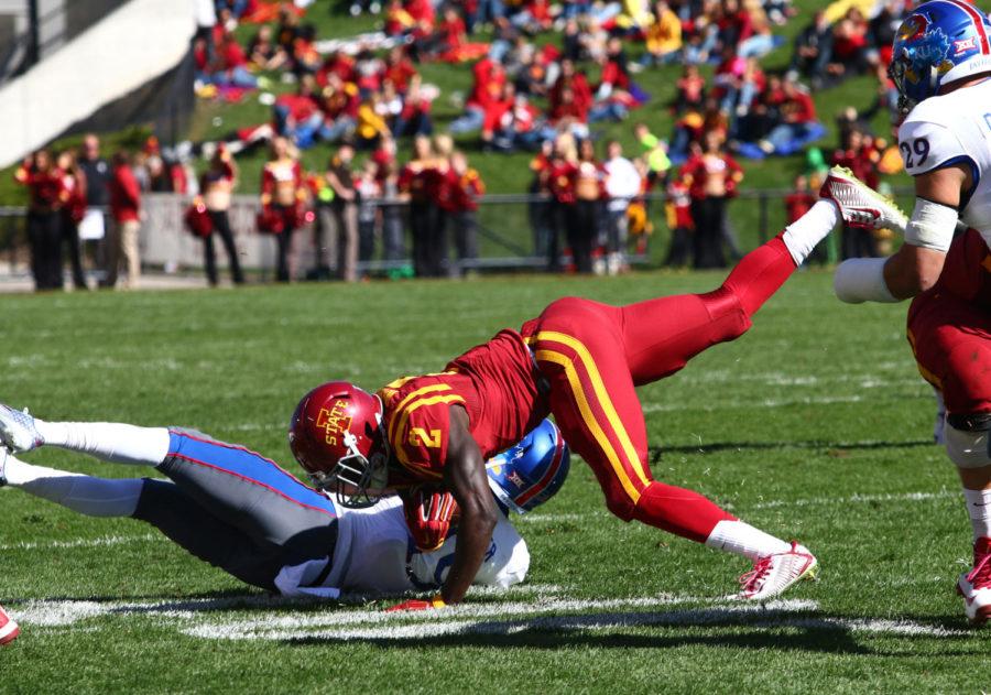 Iowa States running back Mike Warren tackles Kansas cornerback Tyrone Miller, Jr. . The Cyclones would go on to beat the Jayhawks 38-13.  
