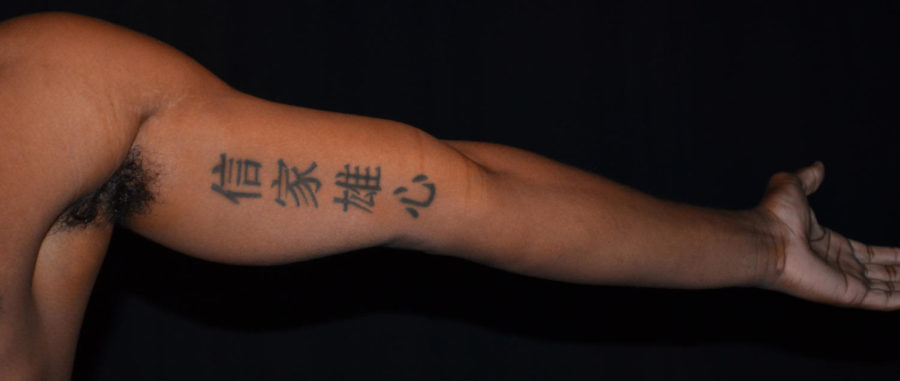 Student models tattoos for photo illustration on the culture of tattoos. With a tattoo under the lower portion of his left arm.