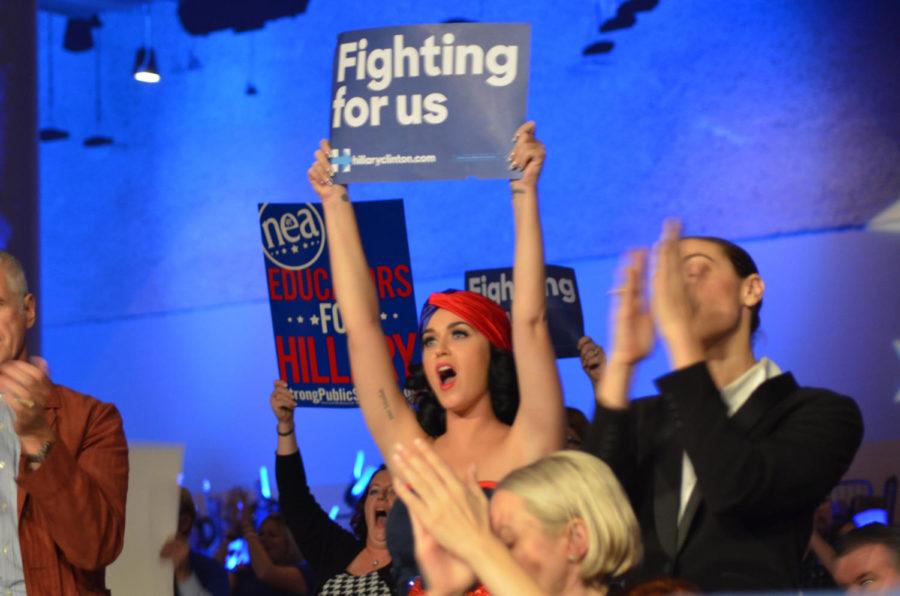 Pop artist Katy Perry holds a sign for Democratic presidential candidate Hillary Clinton at the Iowa Democratic Party’s annual Jefferson-Jackson Dinner in Des Moines on Saturday, Oct. 24. Earlier in the day, Perry held a rally for Clinton along with former President Bill Clinton.