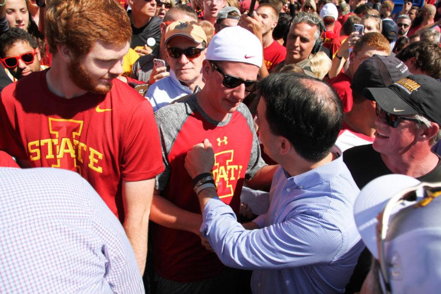 Freshman Taylor Collins shakes hands with Gov. Scott Walker during a Republican meet-up Saturday at Jack Trice Stadium. 