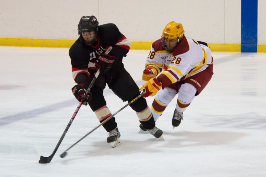 Freshman+Zack+Johnson+%288%29+battles+for+a+puck+against+a+Cougar+defensemen%C2%A0during+a+game+against+the+Southern+Illinois-Edwardsville+Cougars+on+Saturday.+The+Cyclones+won+11-1.