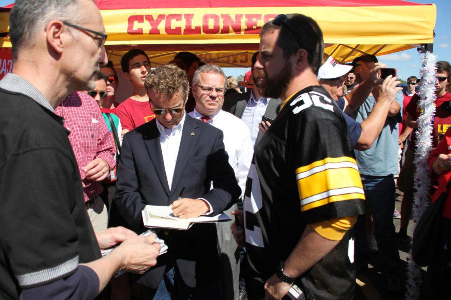 Sen. Rand Paul signs autographs at a meet up outside Jack Trice Stadium on Saturday. 