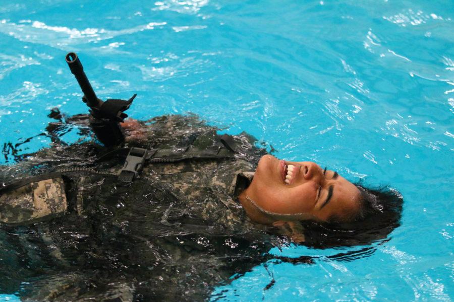 An Army ROTC cadet swims to the side of the pool during the annual Combat Water Survival Training at Beyer Hall on Wednesday evening. Each cadet must pass five different stations, including the 3-meter drop, the 10-minute swim, 5-minute water tread, the gear ditch and the 15-meter gear swim. 