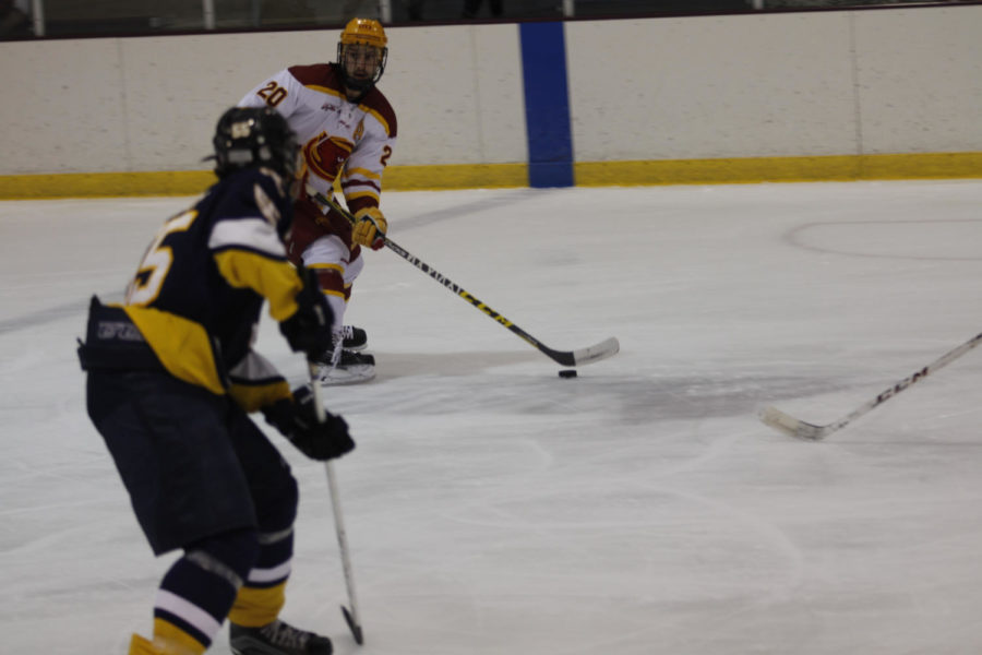 Junior forward Chase Rey passes the puck at the ISU vs Augustana game. The final score was 11-0.