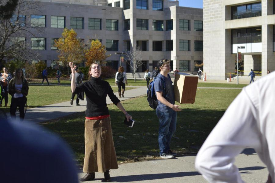 Sister Kirsten delivers a speech in the free speech zone outside Parks Library Nov. 2. Dallas Nicholson, sophomore in computer science drummed on a wooden box throughout the speech.