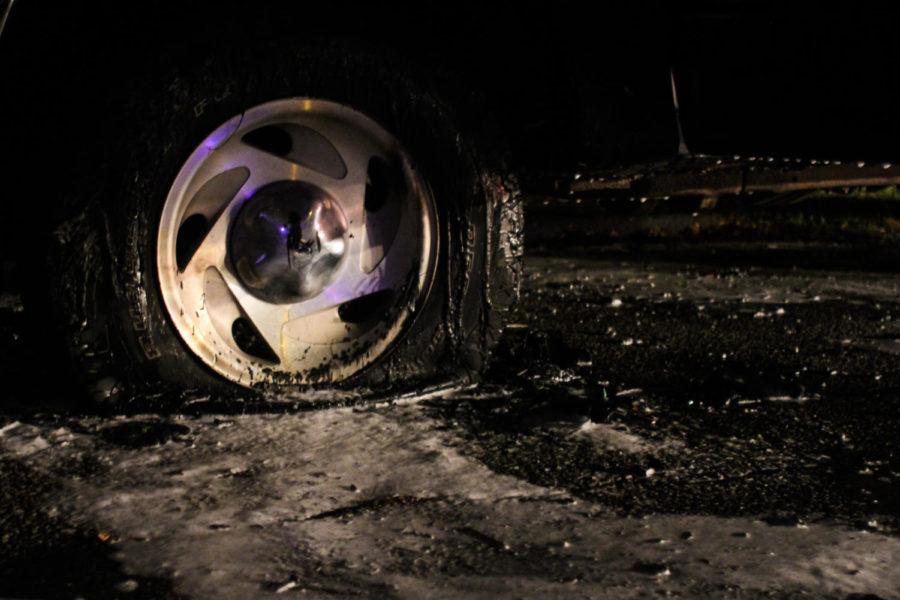 A popped tire sits covered in fire-suppressing foam after the truck caught on fire early Wednesday evening. The Ford F-150 suffered significant damage to the front portion of the cab and the interior. 