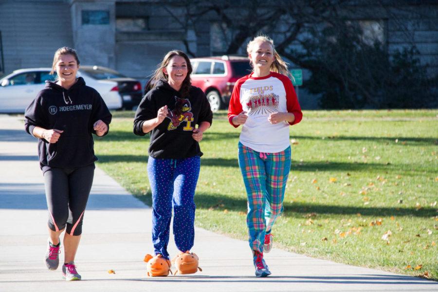 Students cross the starting line of the 2015 Jammie Jog, hosted by the Iowa State Optimist Club. The jog took place around central campus during the afternoon of Nov. 7.