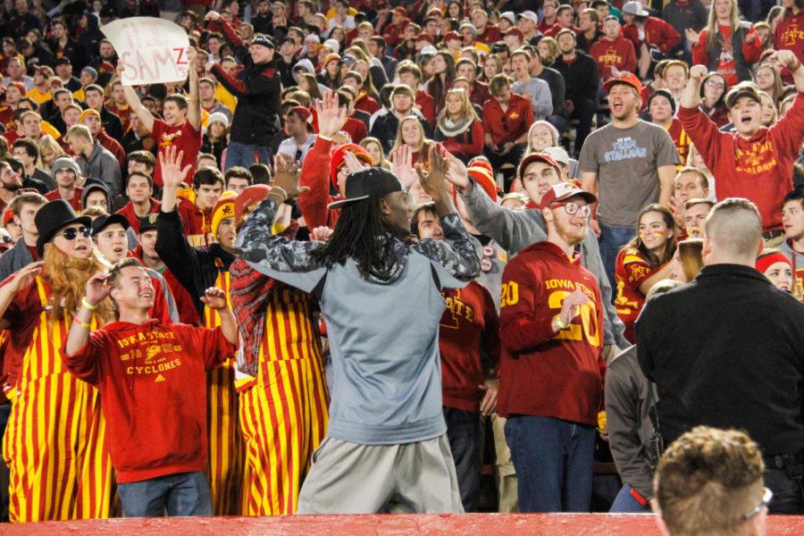 Iowa State freshman basketball player Jameel McKay gives high fives to the crowd during a football game against Oklahoma State University on Nov. 14. The Cyclones would go on to lose 31-35.   