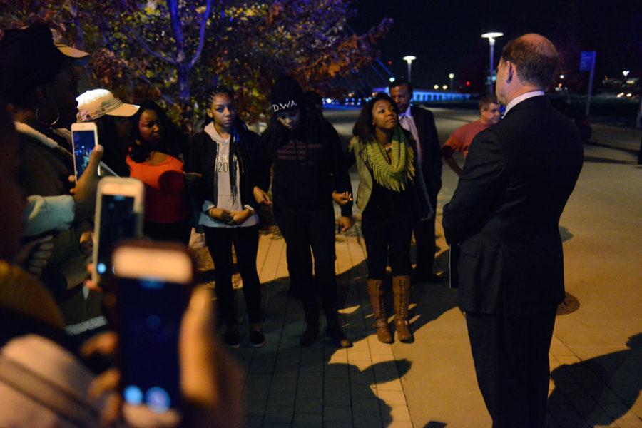 Students from the Concerned Student 1950 group record video on their smartphones as they confront UM System then-President Tim Wolfe outside of the Kauffman Center in Kansas City, Mo., Friday night, Nov. 6, 2015.